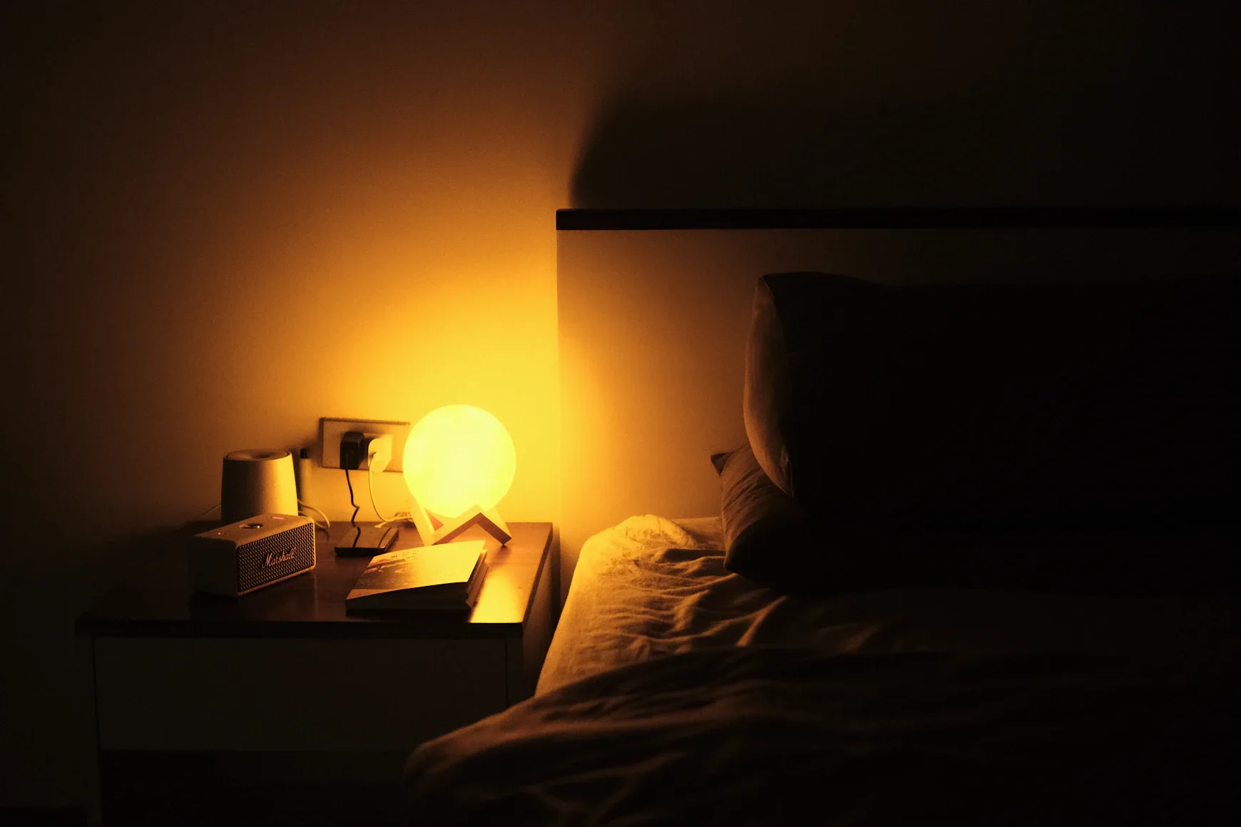 Create a quiet, dark, cool bedroom environment before bed, utilizing blackout curtains, earplugs, or white noise machines. 